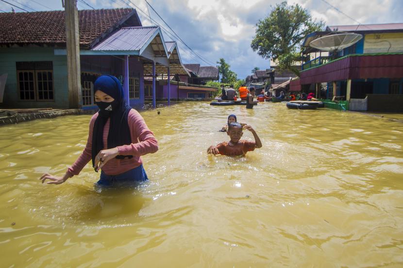 sejumlah-warga-menerobos-banjir-yang-merendam-permukiman-di-jalan_210515134135-118